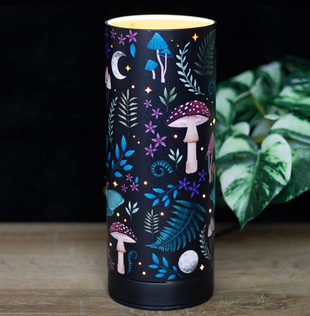 Dark Forest USB Aroma Lamp - lit on wooden surface with plant