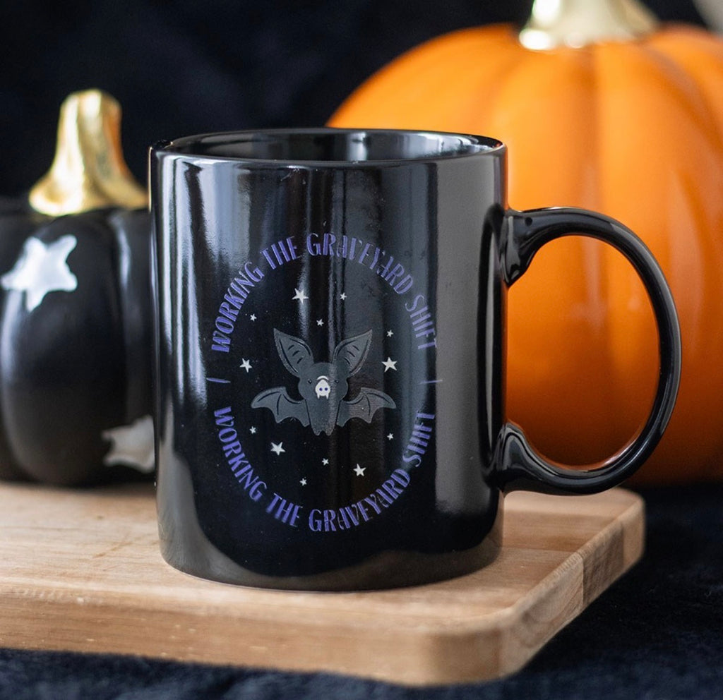 Graveyard Shift Mug styled with Halloween pumpkins