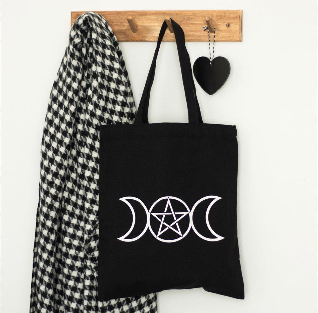Triple Moon tote bag styled hanging on wall hook