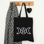 Triple Moon tote bag styled hanging on wall hook