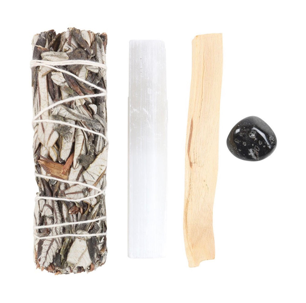 Yerba Santa Energy Cleansing Kit contents laid out — sage bundle, selenite, palo santo and black crystal