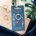 Midnight Hare Keyring lifestyle shot on wooden board with moon earrings