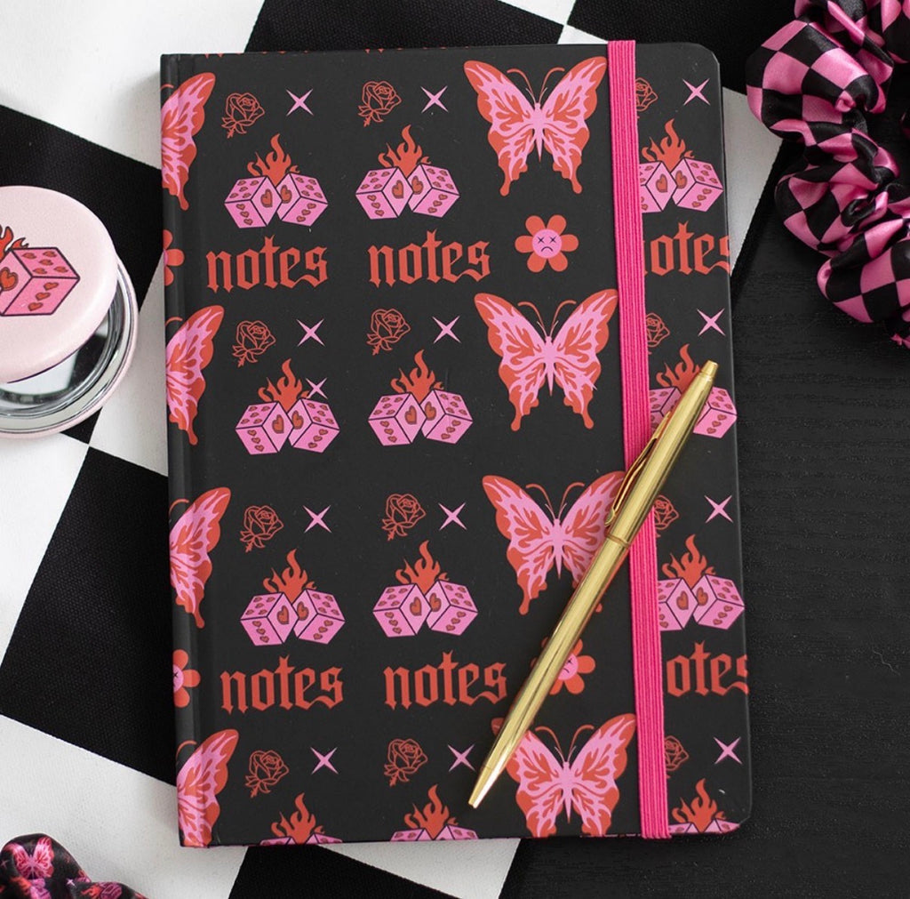 Flaming Butterfly A5 Notebook lifestyle flat lay with pen on checkered background