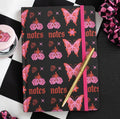Flaming Butterfly A5 Notebook lifestyle flat lay with pen on checkered background
