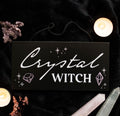 Crystal Witch Hanging Sign lifestyle flat lay with candles and crystals