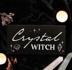 Crystal Witch Hanging Sign lifestyle flat lay with candles and crystals