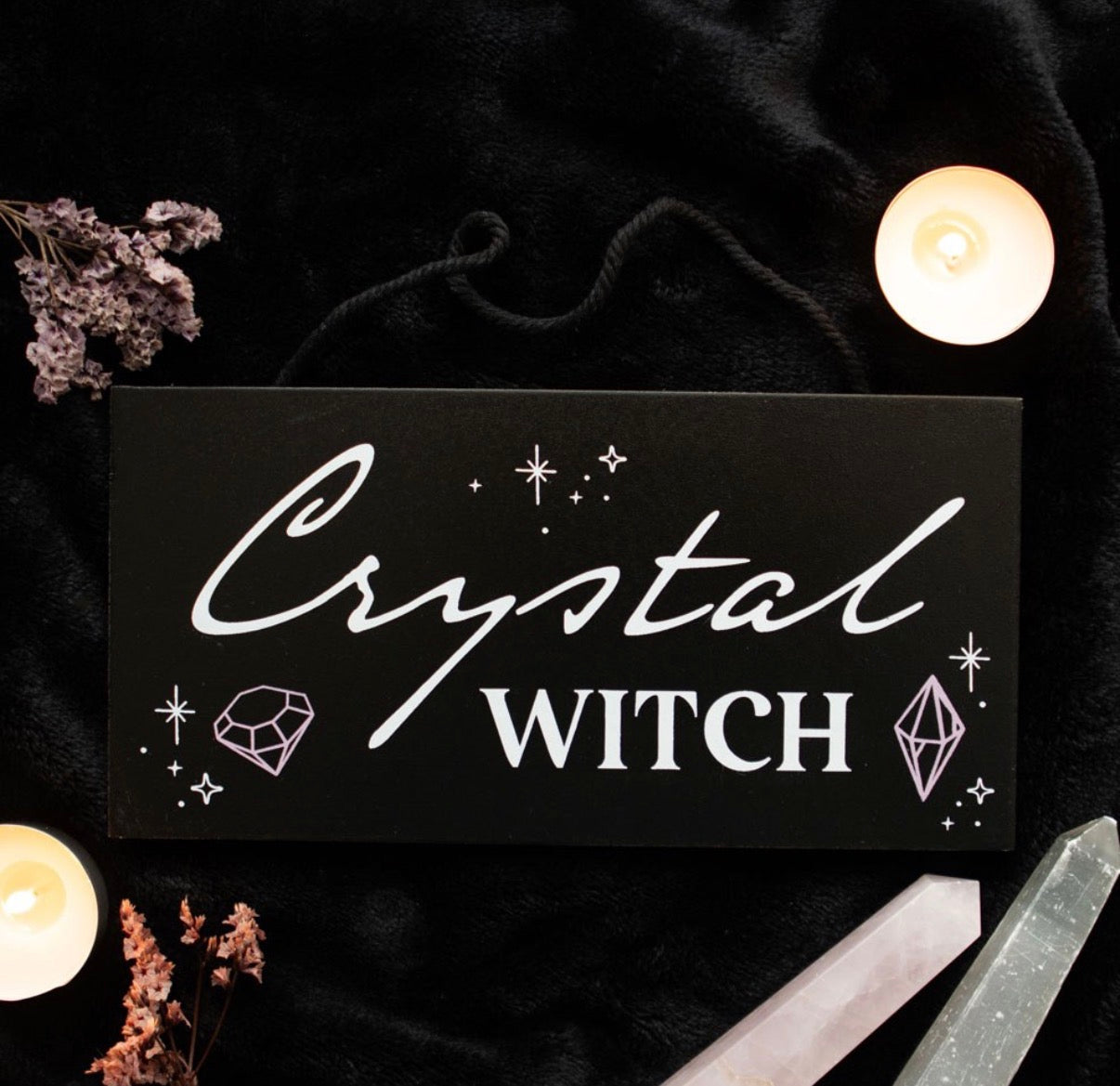 Crystal Witch Hanging Sign lifestyle flat lay with candles and crystals