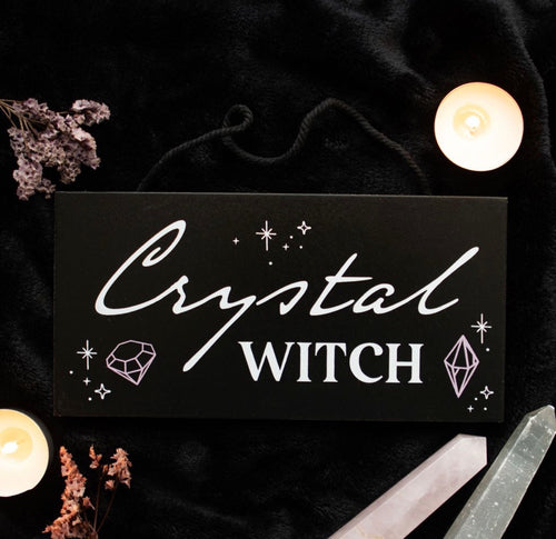 Crystal Witch Hanging Sign lifestyle flat lay with candles and crystals