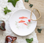 Mushroom Trinket Dish lifestyle flat lay with bracelet, crystals and ivy leaves