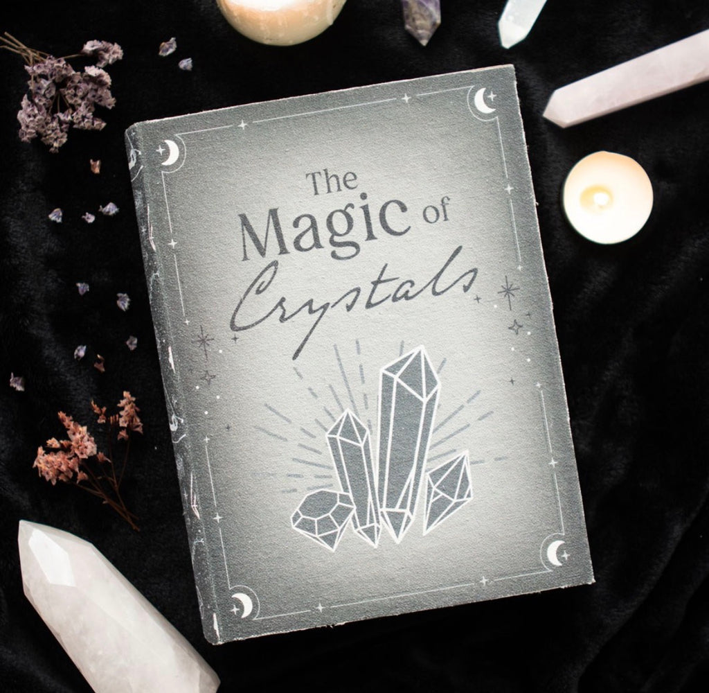 The Magic of Crystals Book Box lifestyle shot on black velvet with crystals and candle