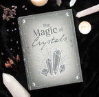 The Magic of Crystals Book Box lifestyle shot on black velvet with crystals and candle
