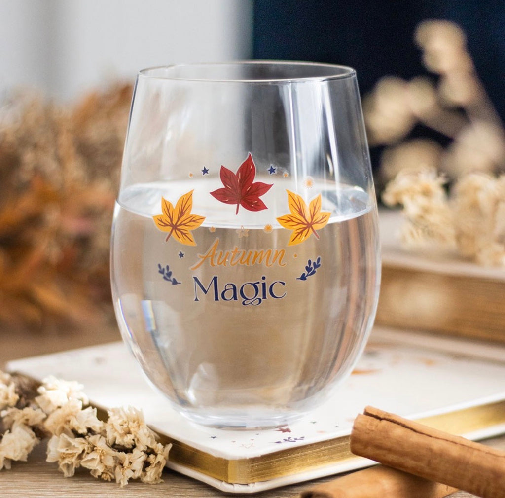 Autumn Magic Stemless Wine Glass lifestyle shot on wooden surface with dried flowers
