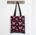 Flaming Butterfly Tote Bag hanging on door hook lifestyle shot