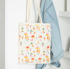 Funky Fungi Mushroom Print Tote Bag lifestyle shot hanging on hook with denim jacket