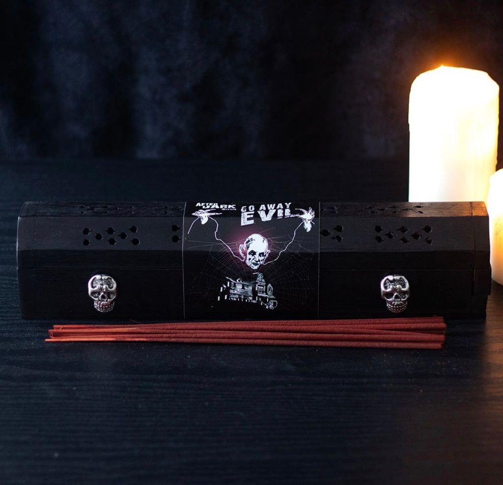 Go Away Evil incense box - lifestyle shot with candle