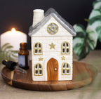 Stone Cottage Ceramic Oil Burner lifestyle shot on wooden tray with candle and essential oil bottle