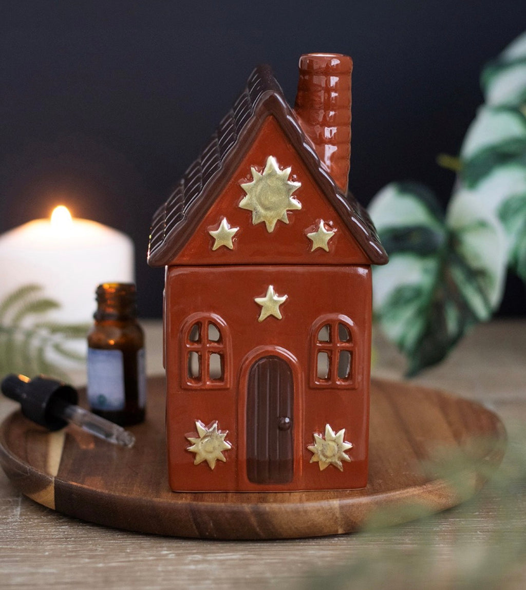 Hearth Cottage Ceramic Oil Burner lifestyle shot on wooden tray with candle and essential oil bottle