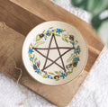 Solstice Wreath Trinket Dish lifestyle shot on wooden board with gold necklace