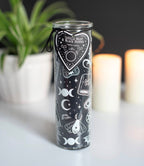 Spellbound Secrets Vanilla Bean and Black Pepper Scented Candle lifestyle shot with plants and candles