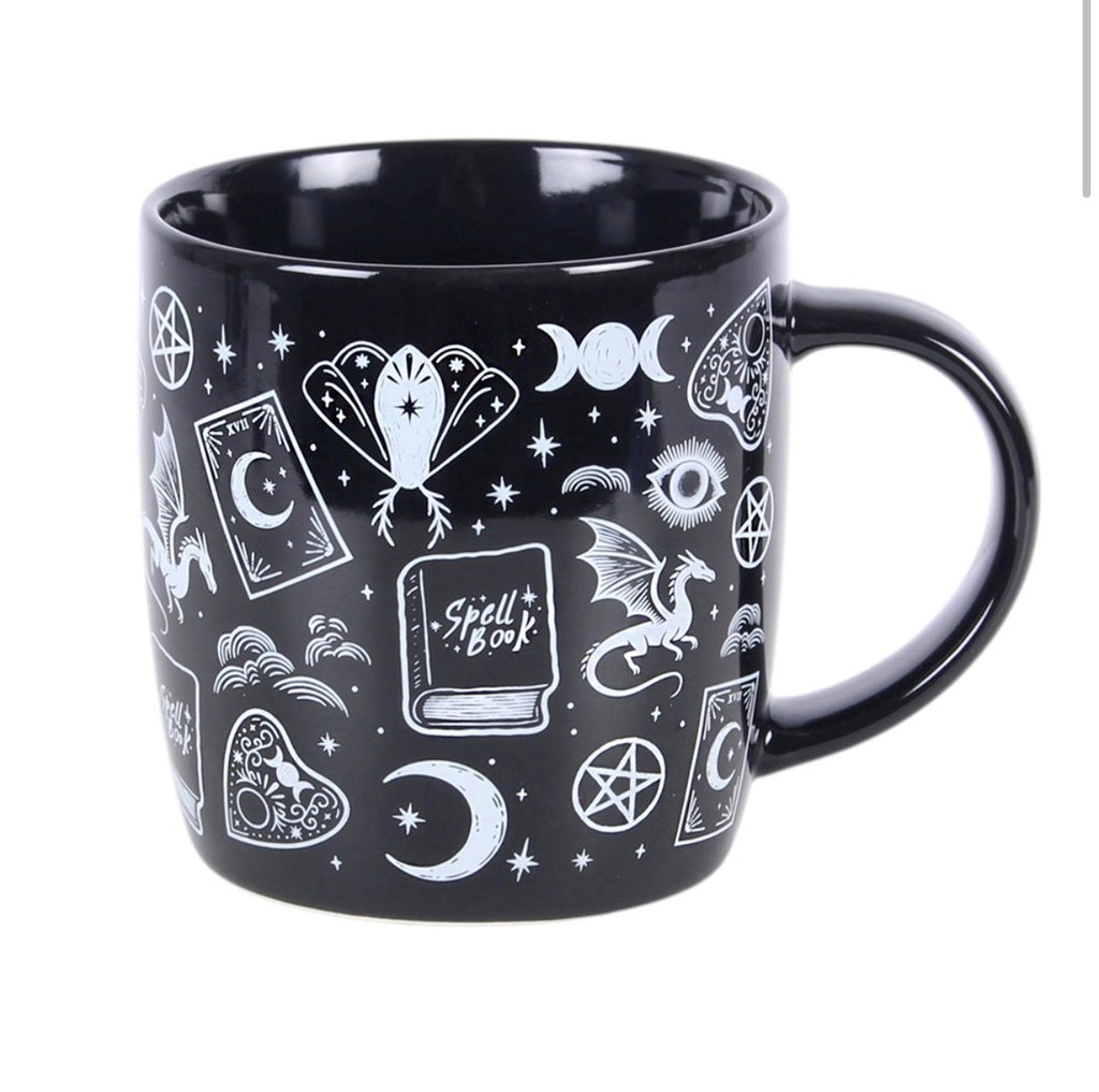 Spellbound Secrets Ceramic Mug front view white background showing spell book and moth