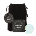 Opalite Gemstone Skull with black velvet pouch and info card white background