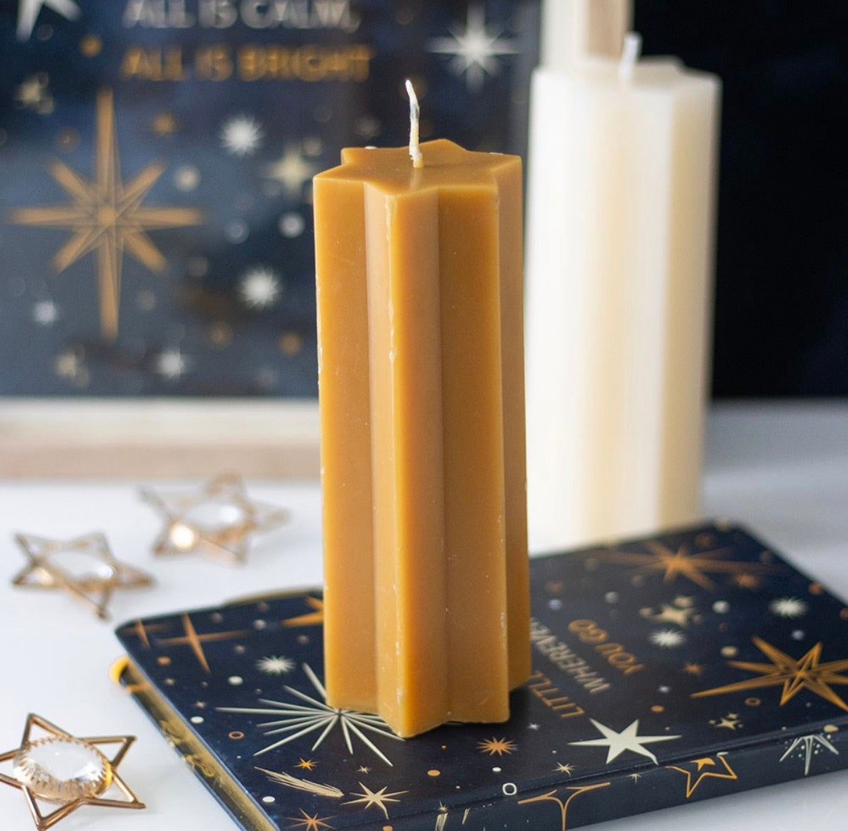 Starry Night star shaped candle gold - close up top white background