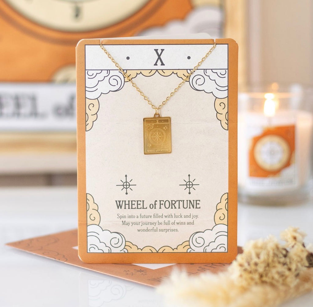 Wheel of Fortune tarot necklace on illustrated backing card - styled shot