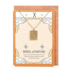 Wheel of Fortune tarot necklace on backing card - front view