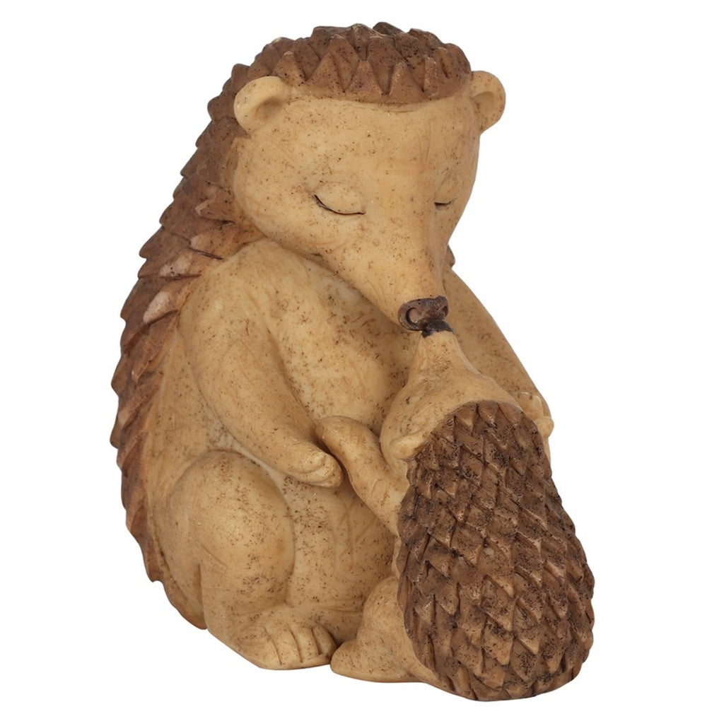 Hedgehog and hoglet figurine side view on white background showing mother cradling baby