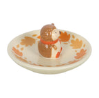 Hedgehog ceramic ring dish side view on white background showing hedgehog figurine and autumn leaf dish detail
