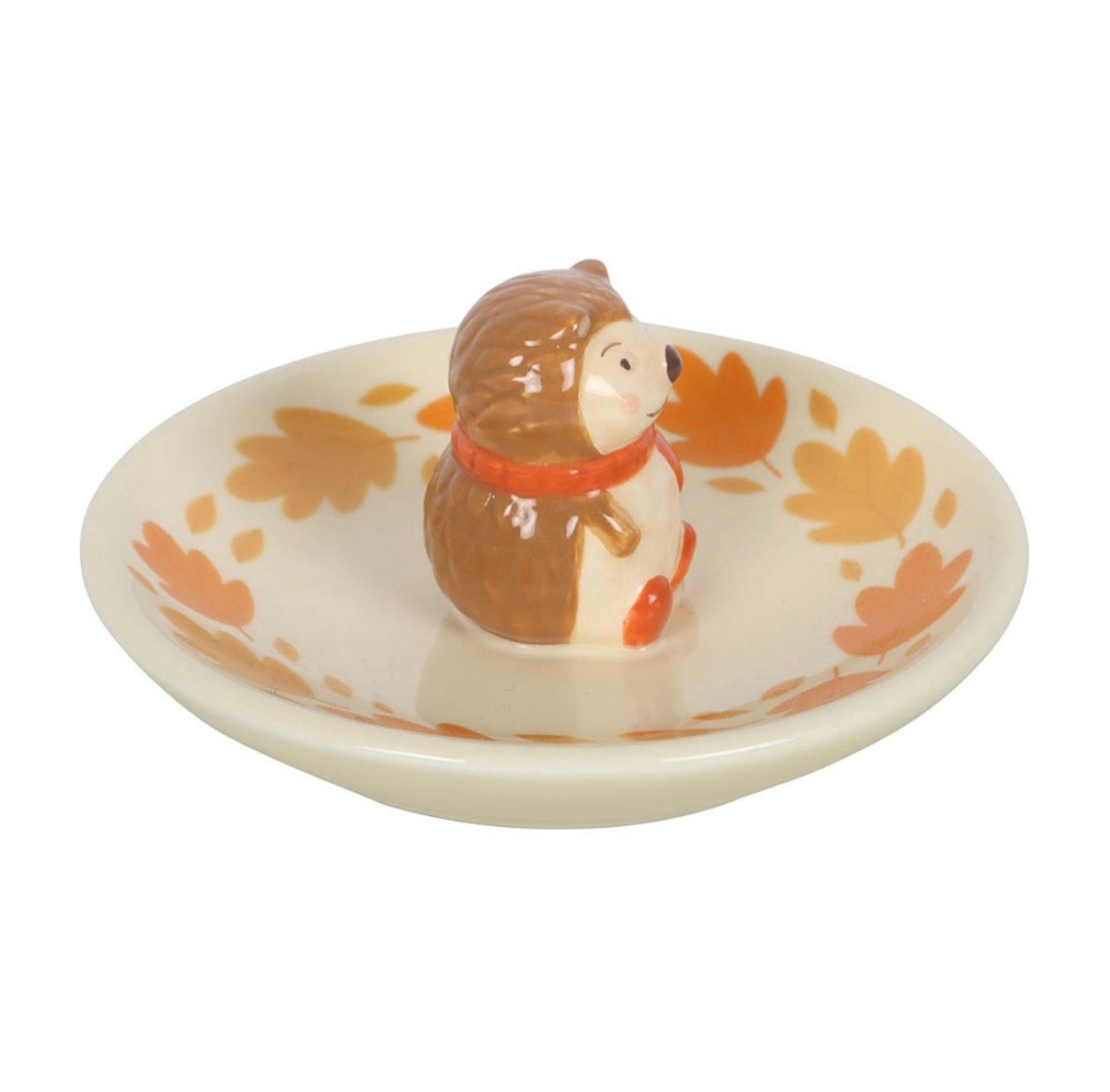 Hedgehog ceramic ring dish side view on white background showing hedgehog figurine and autumn leaf dish detail