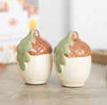 Acorn ceramic salt and pepper shakers lifestyle shot on wooden table with blurred background