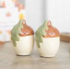 Acorn ceramic salt and pepper shakers lifestyle shot on wooden table with blurred background