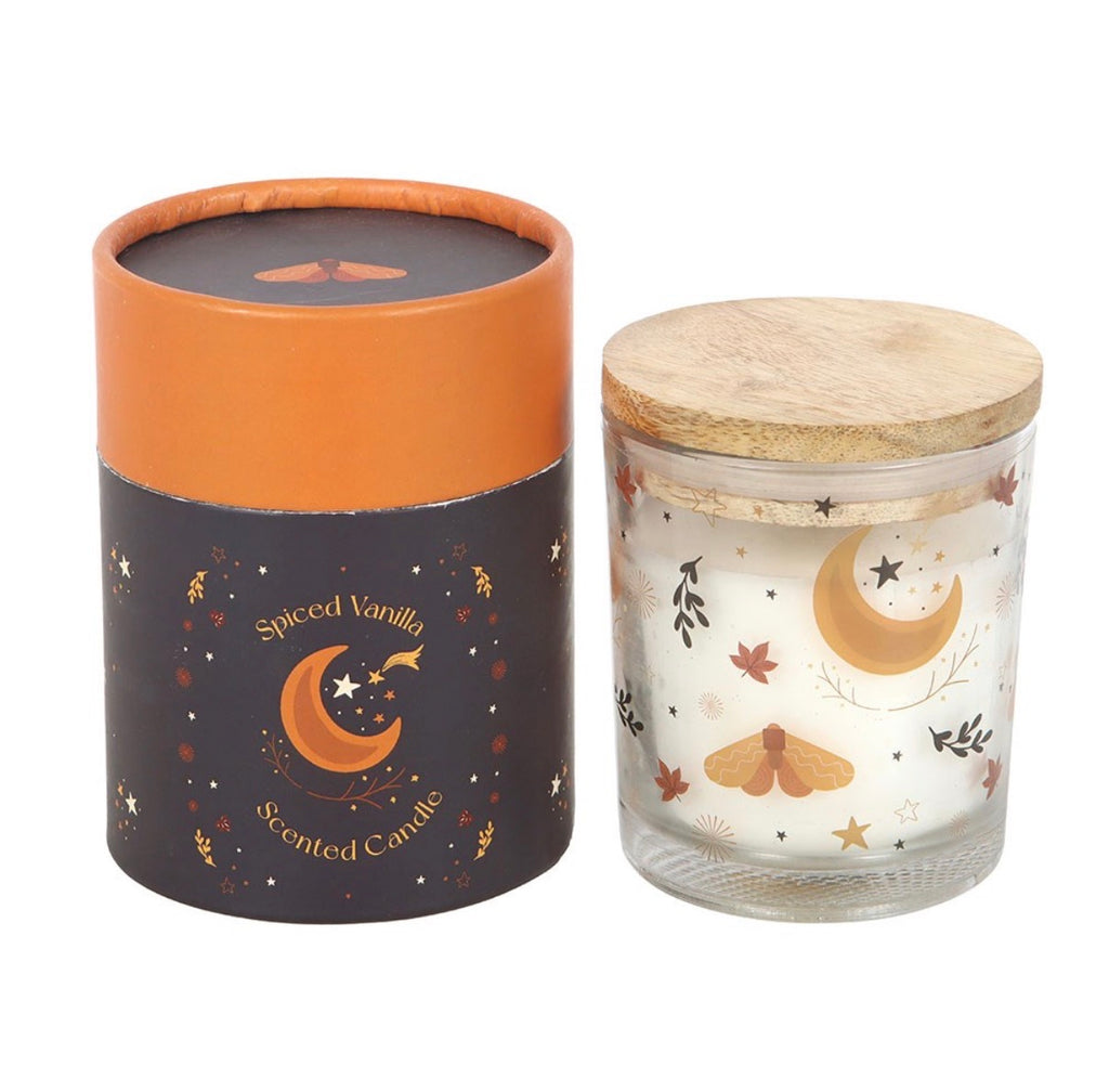 Spiced Vanilla celestial scented candle unlit with wooden lid beside navy gift box on white background