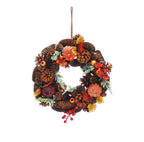 Autumn harvest wreath with pine cones, red berries, amber leaves and jute hanger against a white background