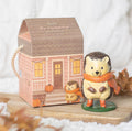Hazel The Hedgehog resin ornament beside cottage house gift box on wooden board with autumn styling