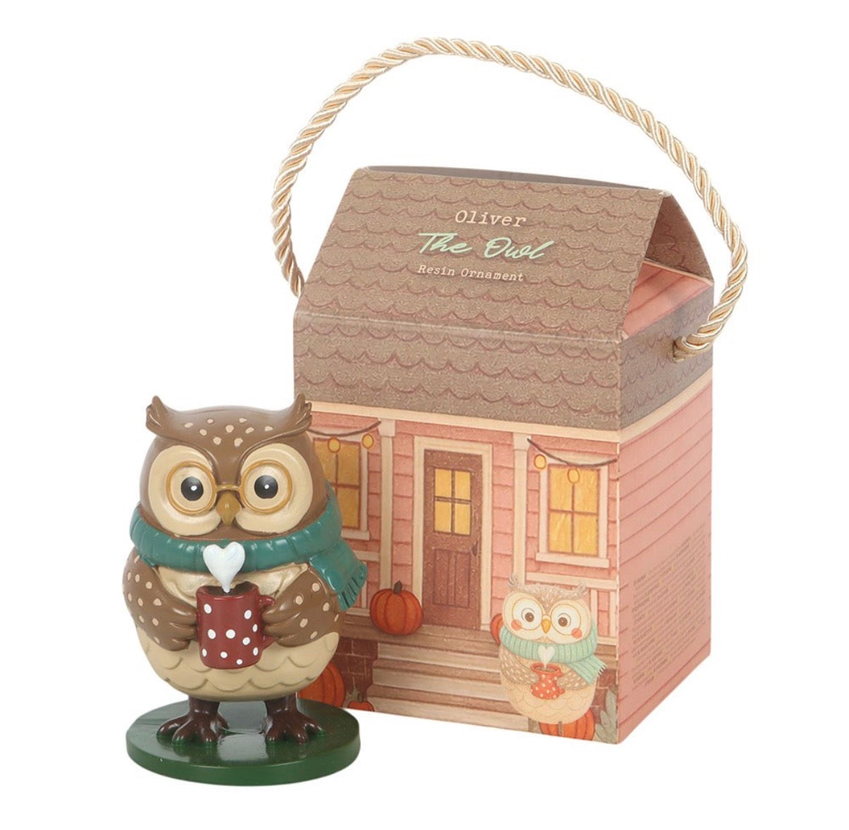 Oliver The Owl resin ornament standing in front of cottage gift box on white background