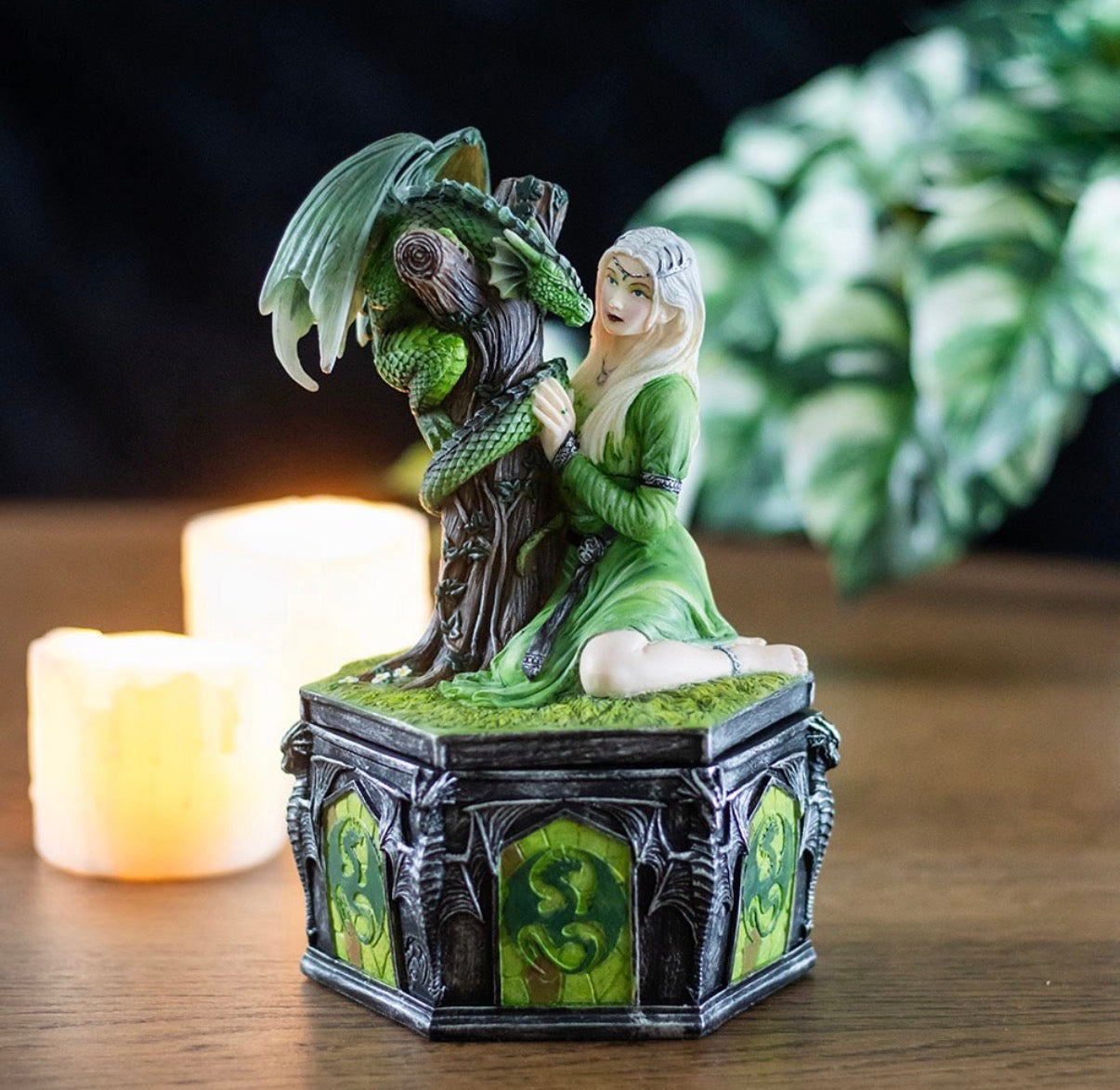 Anne Stokes forest dragon maiden trinket box shown with candle and foliage in moody dark setting