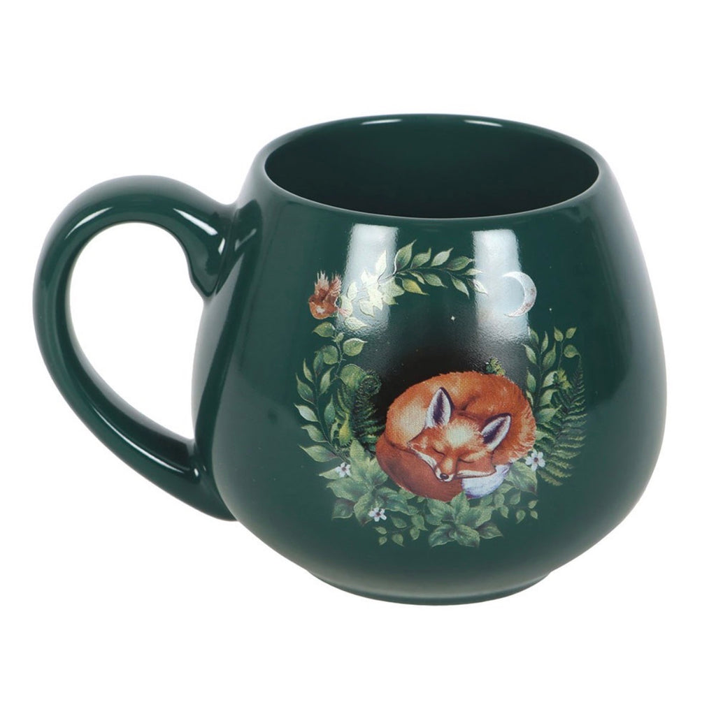 Enchanted Forest Sleeping Fox Mug product shot showing sleeping fox in moonlit botanical wreath on forest green ceramic