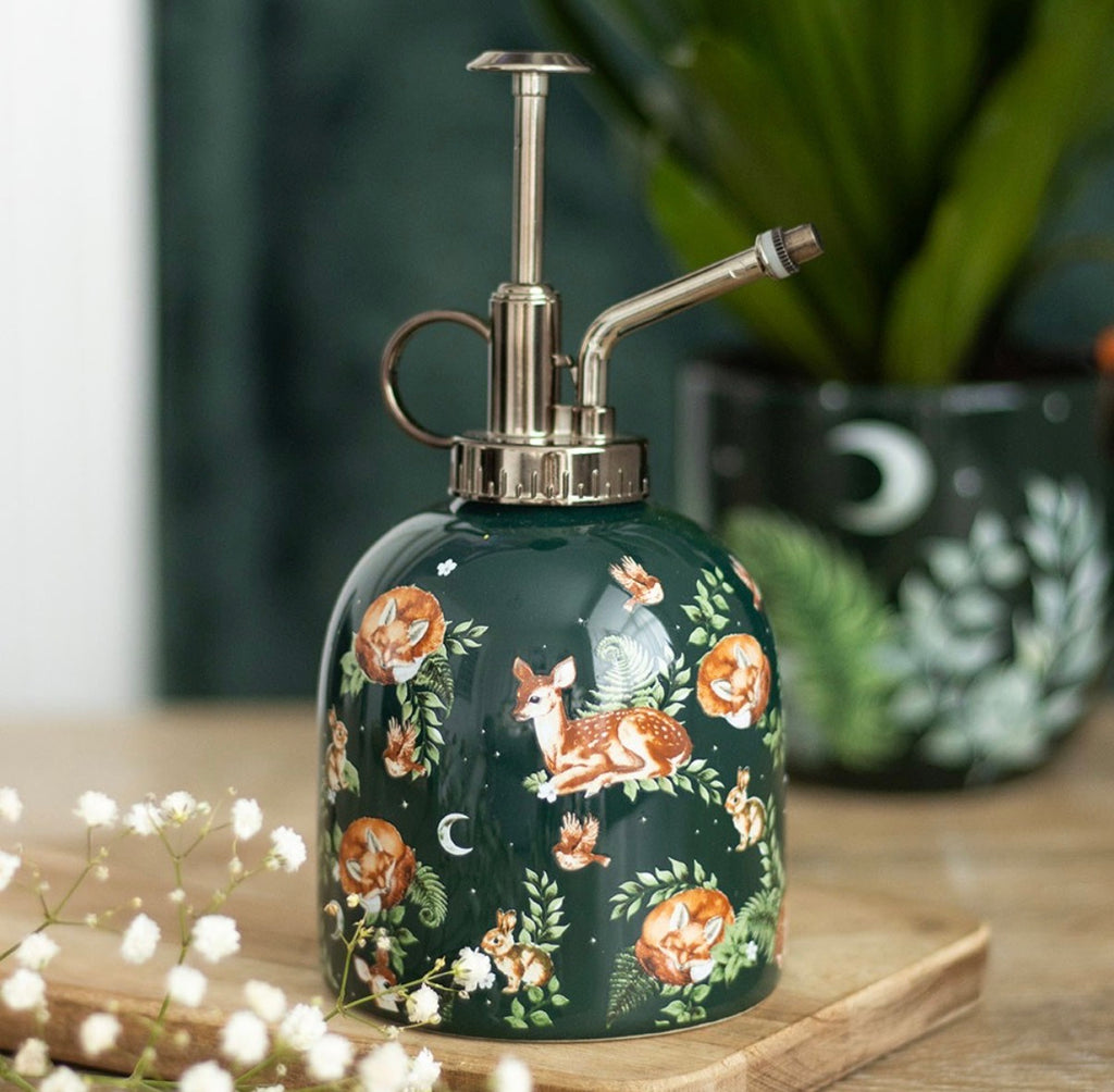 Dark green ceramic forest print plant mister with vintage silver pump, styled with gypsophila flowers and houseplants