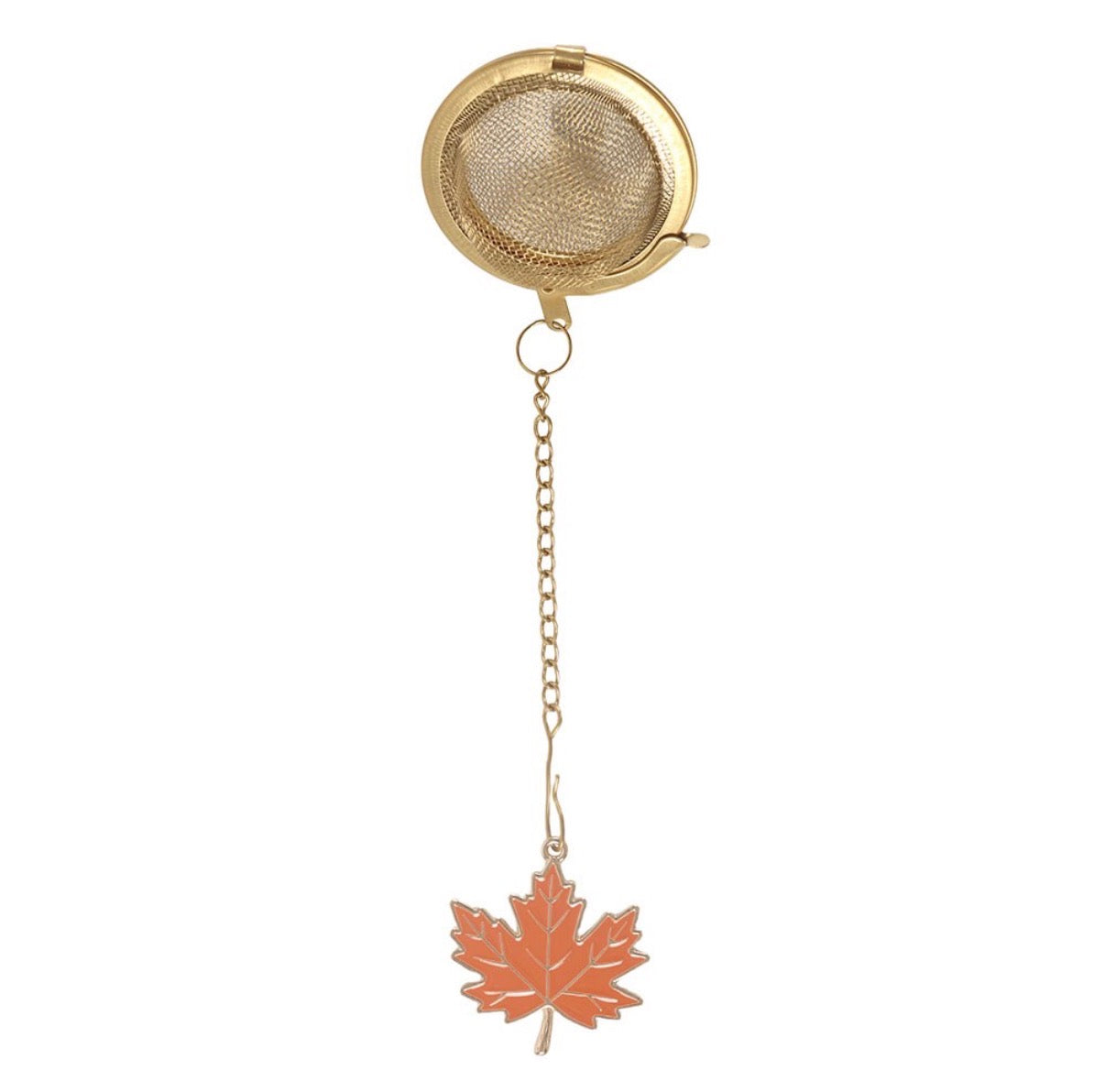 Gold mesh ball tea strainer with enamel maple leaf charm on chain, white background product shot