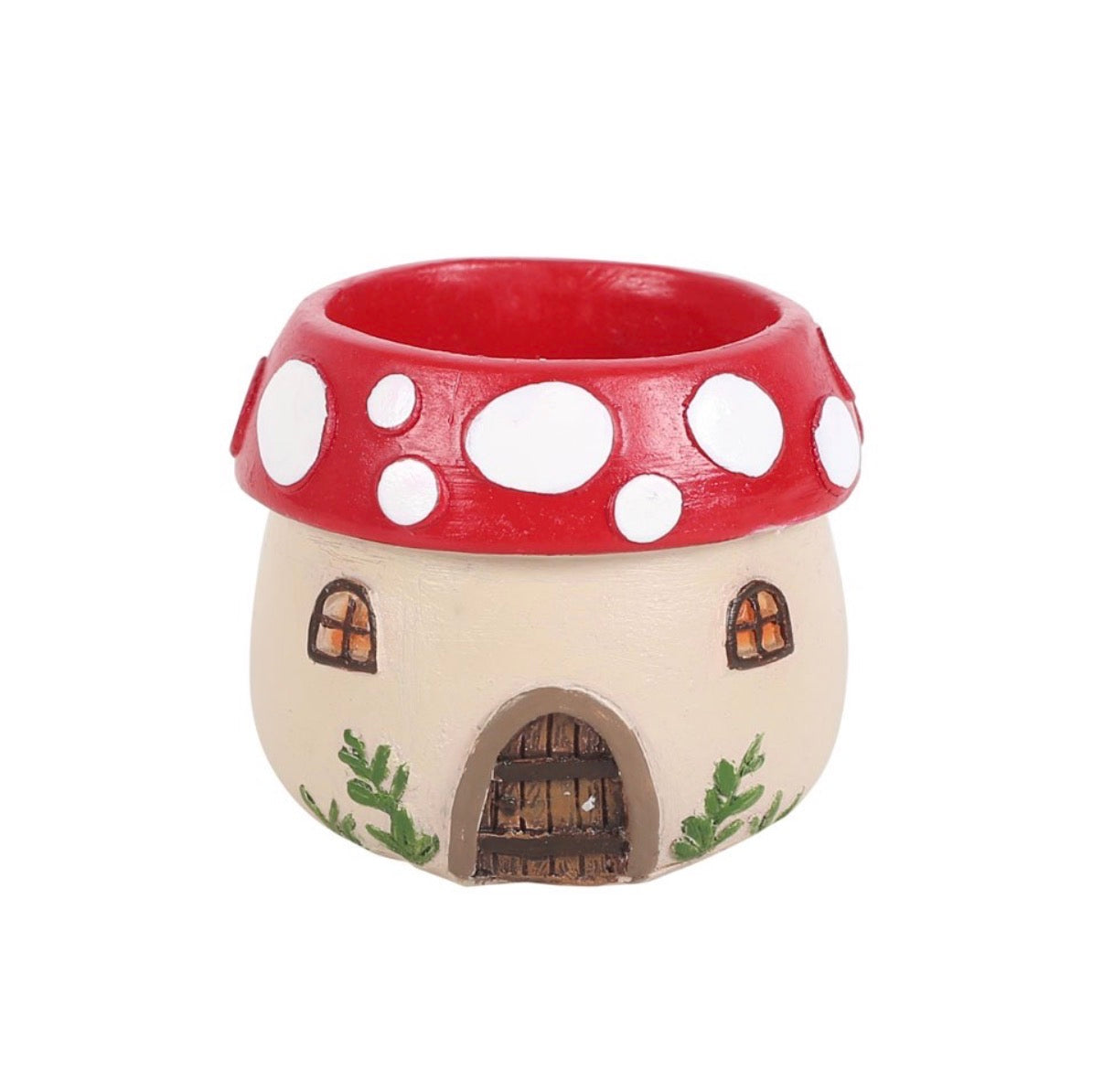 Empty mushroom house tealight holder without candle showing full resin detail, red cap with white spots and painted door and plants, white background