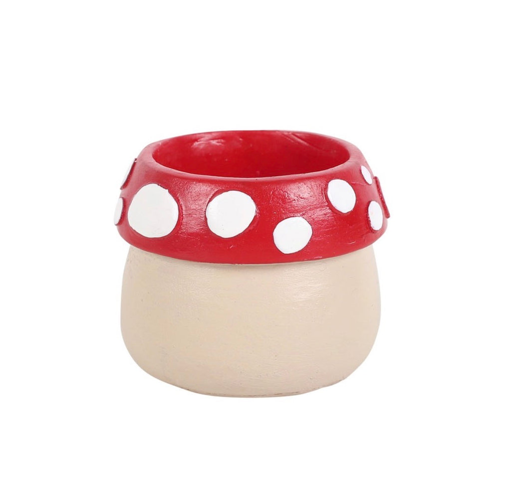 Small plain mushroom tealight holder showing red spotted cap rim and cream body, simpler design, white background