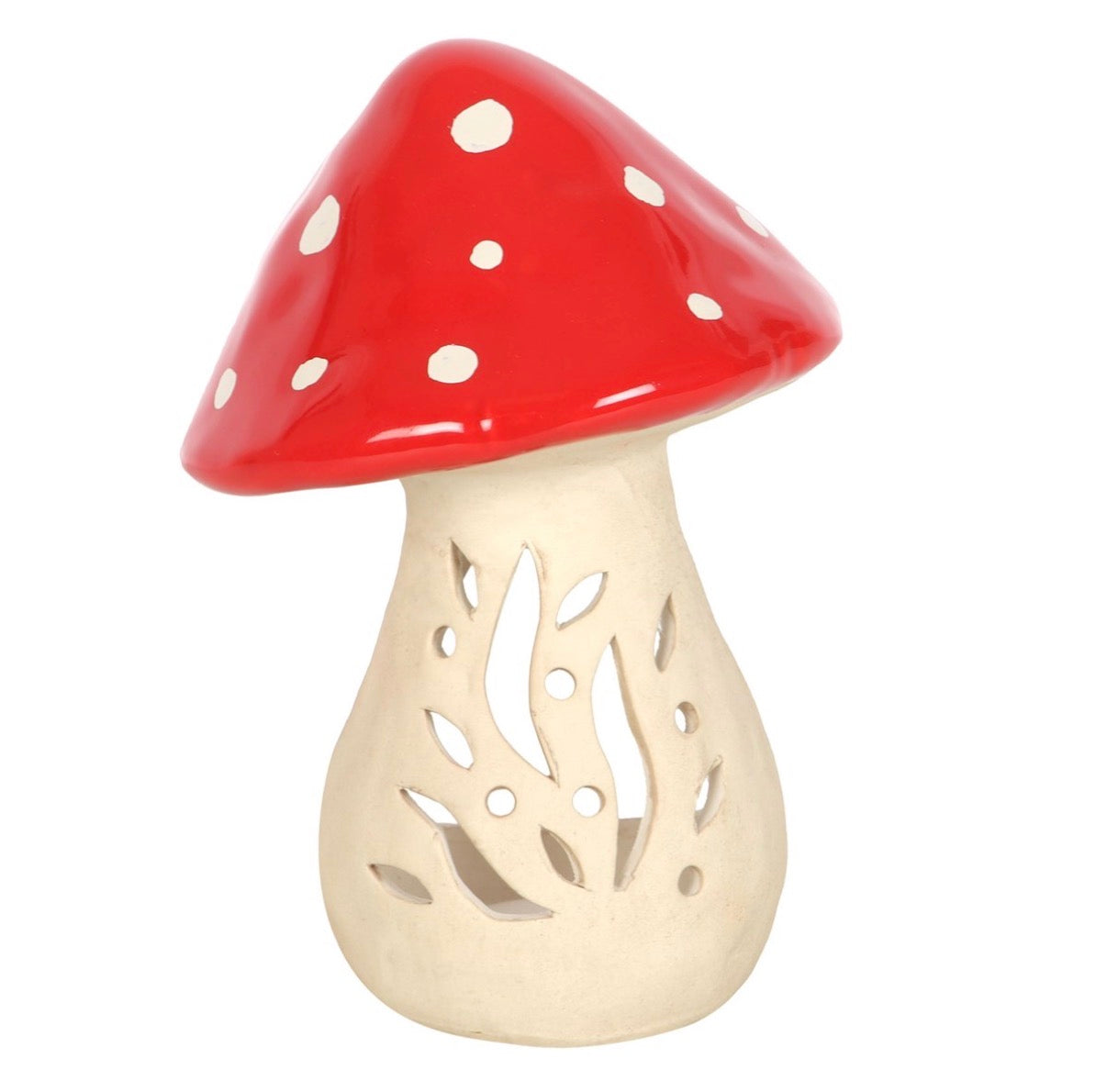 Small ceramic mushroom tealight holder unlit showing cut-out leaf and stem design on cream body with glossy red spotted cap, white background