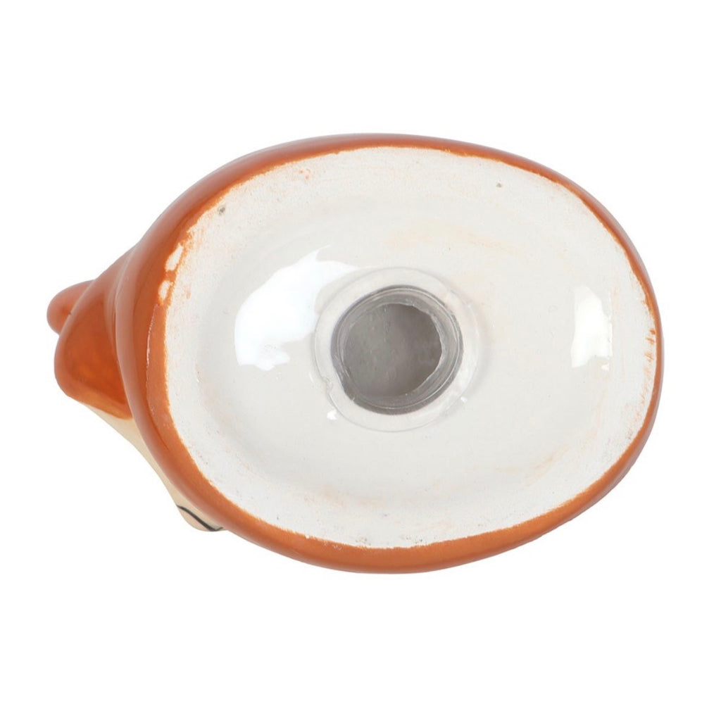 Underside of ceramic fox salt shaker on white background showing white ceramic base with metal refill stopper