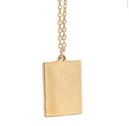 Close-up of the gold Selene pendant showing the etched moon goddess figure
