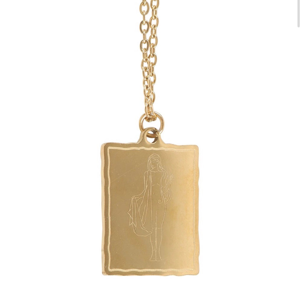 Close-up of the gold Aphrodite pendant showing the etched goddess figure