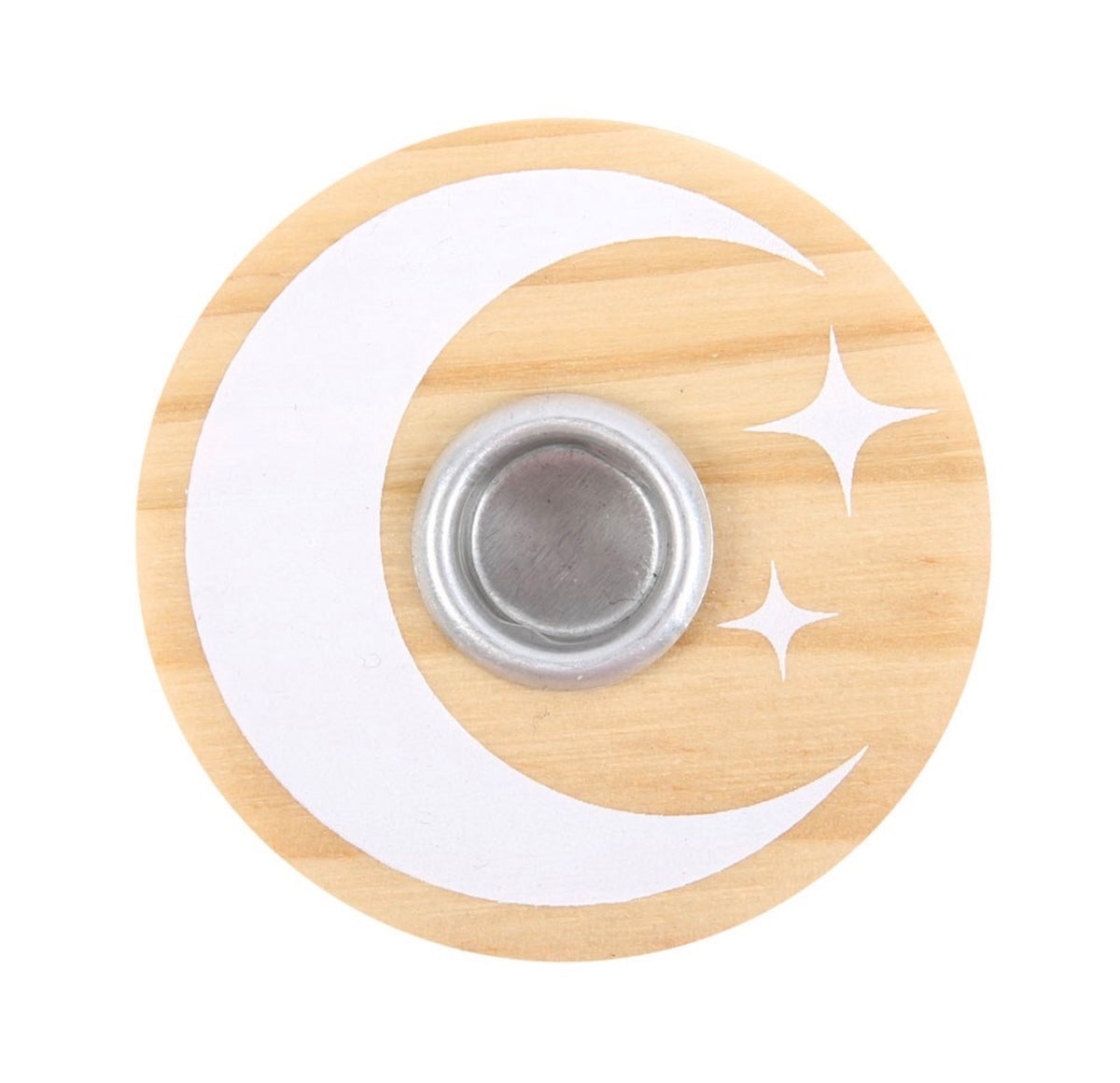 Lit white spell candle in the wooden moon and stars holder, styled with dried flowers