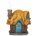 Buttercup Cottage lifted off its stone base with an incense cone in place