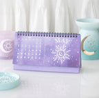 May page of the moon phase calendar showing daily moon phases and a sun illustration